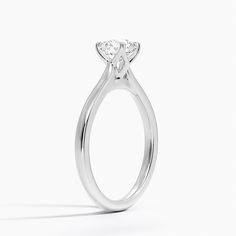 a white gold engagement ring with two pear shaped diamonds on the top and side view