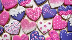 many heart shaped cookies are displayed together