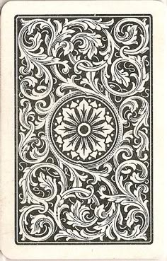 a playing card with an intricate design on the front and back side, in black and white