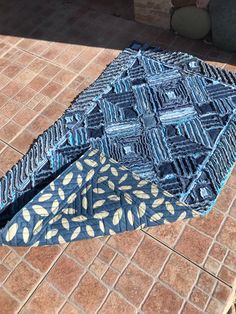 an open umbrella sitting on top of a tiled floor