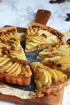 there is a pie that has been cut into pieces and sits on a wooden platter