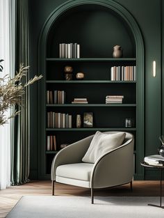 a living room with bookshelves and a chair in front of the bookcase