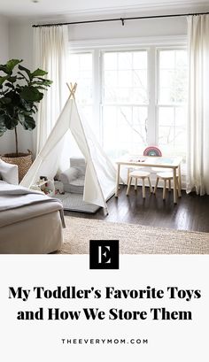 a white teepee tent sitting on top of a wooden floor next to a window