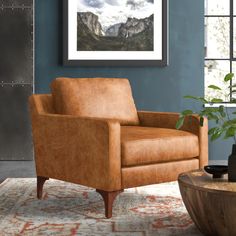 a living room with a brown chair and potted plant