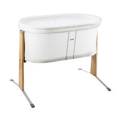 a white bath tub sitting on top of a wooden stand