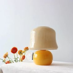 a yellow lamp sitting on top of a white table