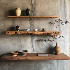 two wooden shelves with vases and bowls on them