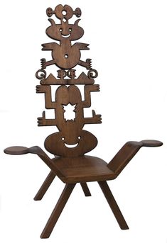 a chair made out of wooden pieces with carvings on the back and legs, sitting in front of a white background