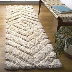 a white rug on the floor in front of a window