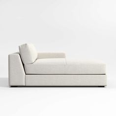 a white couch sitting on top of a white floor