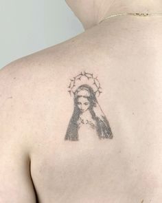 the back of a woman's shoulder with a drawing of a woman on it