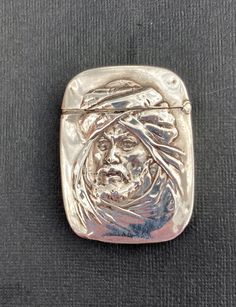 Very Rare antique late 19th century sterling silver vesta. Wonderful embossed portrait of Orientalist man in traditional head gear and beard. It is in good condition with some signs of age and use. This a very unusual vesta making it ideal for any collection. On the back it is engraved with 3 letters and it is marked sterling on the inner lip . Dimensions 6cm x 4.4cm x 0.9cm. Oc Challenge, Head Gear, Vintage Bakelite, Silk Velvet, Rare Antique, Aging Signs, Sterling Silber, Blur, Drake