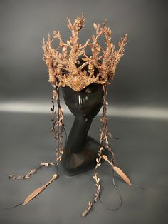 a headpiece made out of branches and leaves