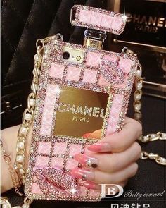 a woman's hand holding a pink phone case