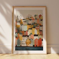 an art print of a cityscape is displayed in a frame on the floor