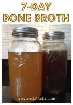 two jars filled with brown liquid sitting on top of a counter next to each other