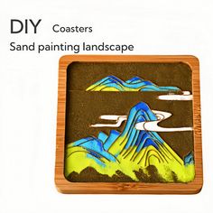 a wooden box with an image of mountains and clouds painted on the inside of it