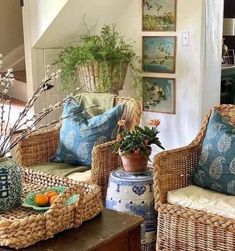 wicker furniture in a living room with blue and white pillows