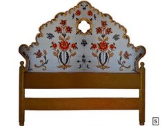 an ornate headboard with flowers and leaves on it