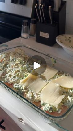 a glass dish filled with food on top of a counter