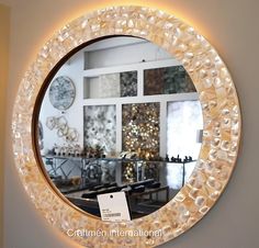 a round mirror hanging on the wall above a table