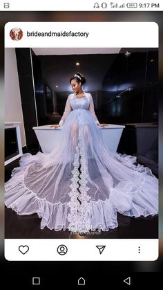 a woman in a white dress standing next to a tub