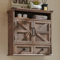 a wooden cabinet with two doors on the front and one door open to reveal towels