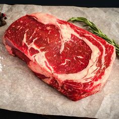 raw meat is shown on a table with salt and pepper sprinkled around it