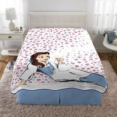 a bed with an image of a woman holding a wine glass on it's side