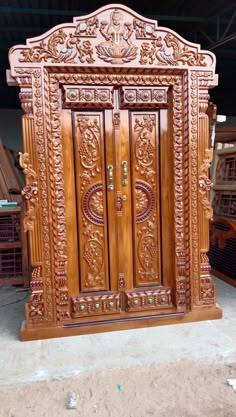 an intricately carved wooden door in a warehouse