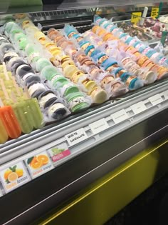 a display case in a grocery store filled with lots of different types of juices