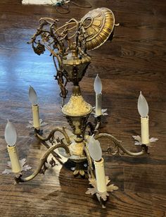 an antique chandelier with many candles on the top and one candle in the middle