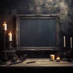 an old photo frame with candles and other items in front of it on a wooden table