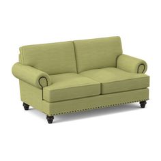 a green couch sitting on top of a white floor