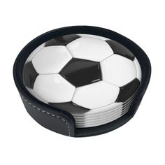 a black and white soccer ball sitting on top of each other in a leather case