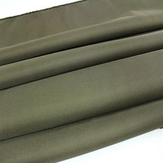 three pieces of dark green fabric folded on top of each other