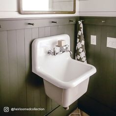 a white sink sitting under a bathroom mirror