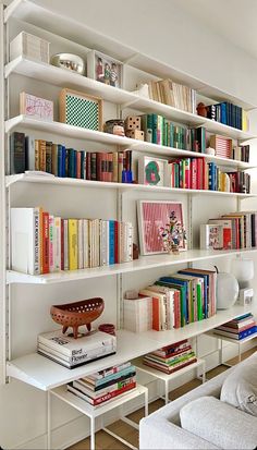 a white book shelf filled with lots of books