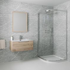 a bathroom with a sink, mirror and stand up shower stall in it's corner