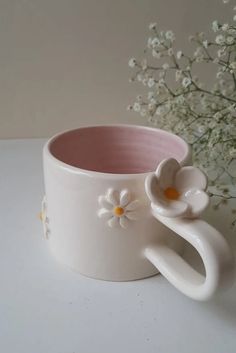 a white coffee cup with flowers on it