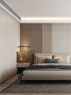 a bedroom with a bed, nightstands and lamps on either side of the bed