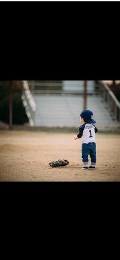 a little boy that is standing in the dirt