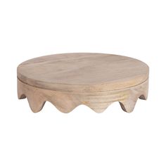 a round wooden table with an unusual design on the top and bottom, made out of wood