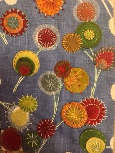 the fabric has been stitched together to make an interesting flower design on it's surface