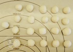 the doughnuts are arranged on a wooden board with measurements for each individual item