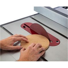 a person using a sanding machine on a piece of wood that is being cut