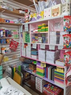 the shelves are filled with lots of books and stationery items for children's crafts