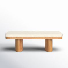 a wooden bench sitting on top of a white floor