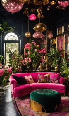 a living room filled with pink couches and lots of flowers