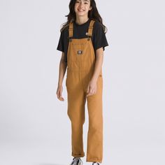 A workwear-inspired overall gets an upgrade in the Kids Groundwork Overalls, blending style and functionality for a fun seasonal look. Featuring a durable canvas build, novelty stitch details, and traditional metal fasteners finished with a simple logo patch at the chest pocket. 100% Cotton fabric Workwear-inspired overall Carpenter-style pockets Metal fasteners Logo patch 24.5'' inseam 14'' leg opening Model wearing size Medium | Vans Kids Groundwork Overalls Small Work Overalls, Jane Clothing, Corduroy Overalls, Vans Kids, Carhartt Women, Rugged Look, Stage Costume, Simple Logo, Clothing Essentials